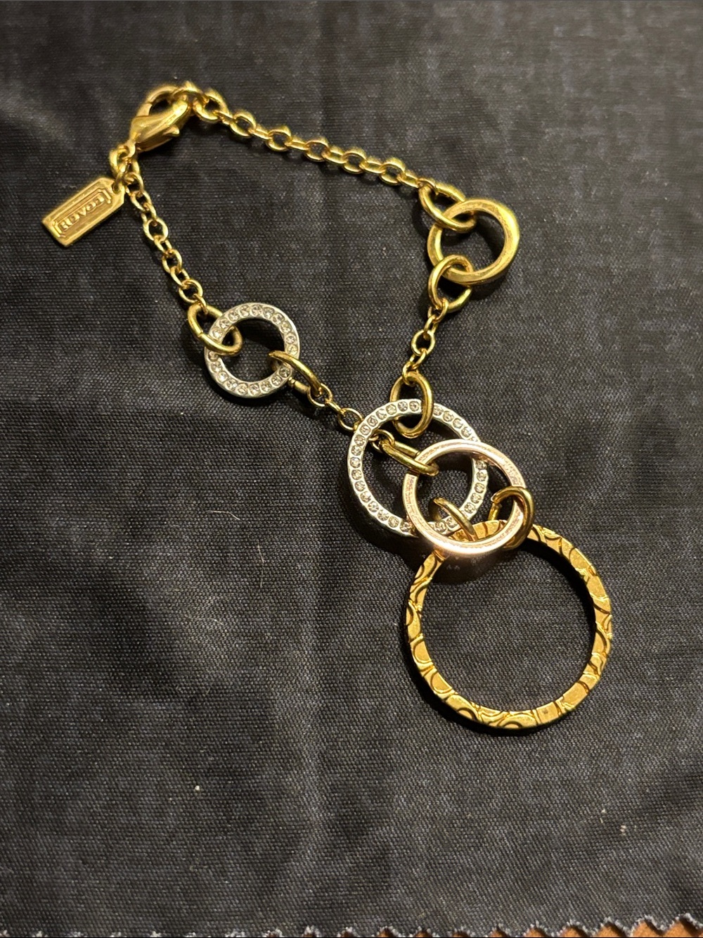 Coach Gold-Tone Interlocking Circle Pendant Bracelet with Crystal Accents